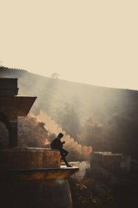 Photograph of a person on the walls of a fort in Asia. They are alone and look more so because of the hazy. 