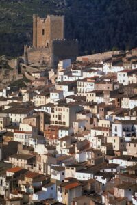 Image of a Spanish castle above a town.