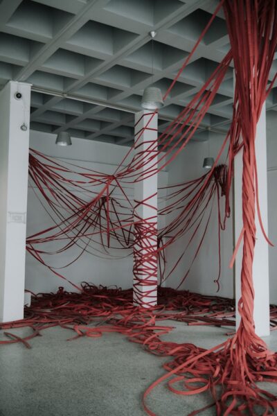 A room full of red tape as a metaphor for the message: The patent office was an original user of red tape.