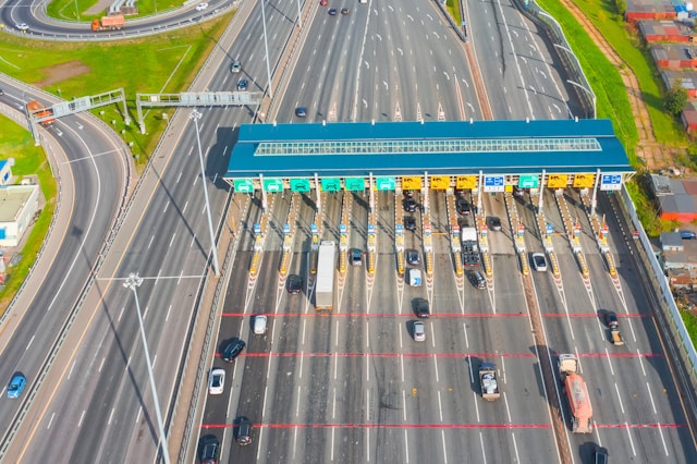 A toll plaza as viewed from the air. The image is a metaphor for the message: The patent office is tolling your innovations. Fees are going up and they want to change your behaviour. 