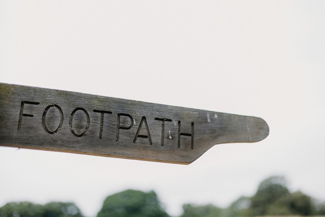 An image of a wood sign reading "footpath".