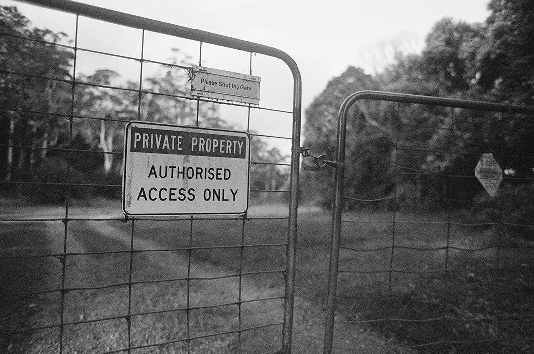 A gate showing a no trespassing sign in much like a patent pending notice.