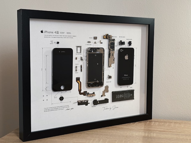 A framed disassembled IPhone 4. It reminds us of the difference between product and invention. 